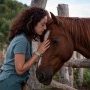 Woman forming a bond with a horse — Oneness