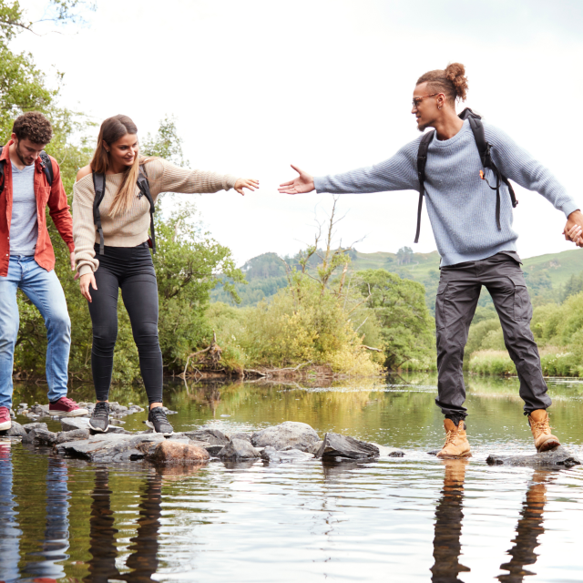 Community crossing a river together